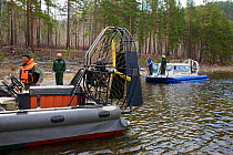 Small hovercraft (in front) and Hivus-10 hovercraft on the expedition on Temnik river, Baikal Nature Reserve, Buryatia, Siberia, Russia, May 2015.