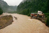 Sense river  in flood with burst  banks and house destroyed by the flood,  Sodbach, Canton Fribourg, Switzerland, August 2005.  Photographed for the Freshwater Project.