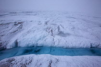 Snow storm at meltwater lake,  Sermeq Kujalleq Glacier, close to the Kangia River, Ilulissat Icefjord UNESCO World Heritage Site, Sermersuaq / Greenland ice sheet, Greenland, August 2014. Photographed...