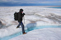 Photographer Michel Roggo at work on the ice cap above the Sermeq Kujalleq Glacier, close to the Kangia River, Ilulissat Icefjord UNESCO World Heritage Site, Sermersuaq / Greenland ice sheet, Greenlan...