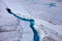Aerial view of ice cap north-east of Sermeq Kujalleq Glacier with meltwater channel disappearing in a moulin, Sermersuaq / Greenland ice sheet, Greenland, Photographed for The Freshwater Project