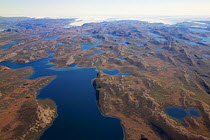 Aerial view of the landscape of the south-west coast of Greenlandbetween Kangerlussuaq and Ilulissat, with glaciers stretching out of the ice shield towards the sea.  Ilulissat Icefjord UNESCO World H...
