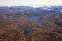 Aerial view of the landscape of the south-west coast of Greenland between Kangerlussuaq and Ilulissat, with glaciers stretching out of the ice shield towards the sea.  Ilulissat Icefjord UNESCO World...