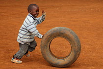 Child playing with tire, near Eldoret, Kenya, July 2017.