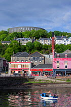Oban Distillery and McCaig's Tower on Battery Hill overlooking the city Oban, Argyll and Bute, Scotland, UK, June 2017