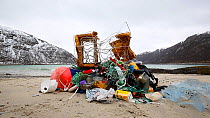 Time lapse of people emptying plastic bags full of marine litter to show what has been collected during a beach clean, Tussoya, Troms, Norway, 2017.