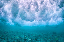 Wave breaking over the rubble zone close to the reef crest of a coral reef. Baa Atoll, Maldives. Indian Ocean.