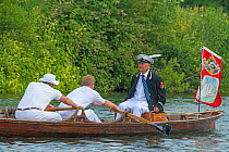 Men in row boat during  Swan upping, the annual census and marking of the Swans on the River Thames. England, UK, July 2016.
