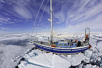 Sailing boat trapped into the ice, Spitsbergen, Svalbard, Norwegian archipelago, Norway, Arctic Ocean, July 2014.