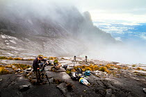 Camera operator Richard Kirby filming on the summit of Mount Kinabalu, Borneo, May 2013.