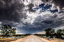 Storm clouds  with rain falling and road bridge in Western Australia, October 2013.