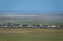 A village on the shores of the dried basin of Lake Zun-Torey, Daurian Nature Reserve. Daurian Steppes UNESCO World Heritage Site, Zabaykalsky Krai, Siberia, Russia, June 2016.