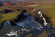Helicopter over waterfall in Putoransky State Nature Reserve, Putorana Plateau, Siberia, Russia