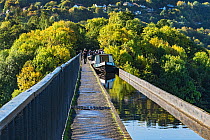 Canal barges crossing the Pont-Cysyllte aqueduct, heading north over the River Dee, near Trevor in the Vale of Llangollen, North Wales, UK September 2017.