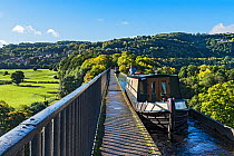 Canal barges crossing the Pont-Cysyllte aqueduct, heading north over the River Dee, near Trevor in the Vale of Llangollen, North Wales, UK September 2017.