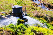 House with home made small scale hydro turbine to provide electricity,  Isle of Eigg, Scotland, UK, May 2012.
