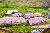 The Black House village at Garenin near Carloway, Isle of Lewis, Outer Hebrides, Scotland, UK. June 2015.  These ancient traditional houses have been preserved, after they were abandoned finally in th...