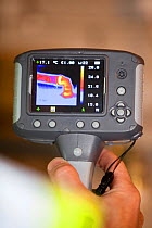 Thermal imaging camera showing heat loss from a hot water pipe.