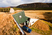 Environmentally friendly house that was built in the 1970's but still exceeds green build regulation today, at Feshiebridge, Cairngorm, Scotland, UK,  March 2012.