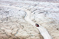 Tourist ice buggy's on the Athabasca glacier, which has lost 60 percent of its ice in the last 150 years. Rocky Mountains, Alberta, Canada. August 2012.