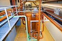Pipes carrying steam to the steam turbines in Krafla geothermal power station. Krafla produces electricity as well as supplying hot water to heat buildings in the surrounding area. September 2010.