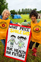 Protestors with a protest banner against fracking at a farm site at Little Plumpton near Blackpool, Lancashire, UK, where the council for the first time in the UK, has granted planning permission for...