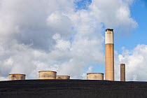 Ratcliffe on Soar coal fired power station near Nottingham, UK, showing the cooling towers and chimney rearing up from a mountain of coal