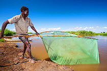 A fisherman catching small fish in the Shire river in Nsanje, Malawi. March 2015.