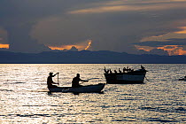 Fisherman in a traditional dug out canoe at Cape Maclear, on Lake Malawi, Malawi, Africa.