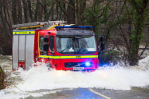 Fire engine going through flood waters on the Ambleside, Coniston road, Rothay bridge,  Lake District on Saturday 5th December 2015, during torrential rain from storm Desmond. England, UK, December 20...
