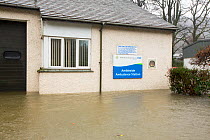 Ambleside Ambulance Station surrounded by flood waters by the banks of the River Rothay in Ambleside, in the Lake District on Saturday 5th December 2015, during torrential rain from storm Desmond. Eng...