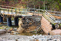 Low Bridge End Farm in St Johns in the Vale, near Keswick, Lake District, UK, with access bridge destroyed by the floods from Storm Desmond. England, UK, December 2015.