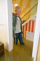Resident inside flooded house, Toll Bar near Doncaster, South Yorkshire, England, UK, 28th July 2007.