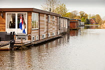 Floating houses on  canal near Amsterdam, Netherlands. April 2013.