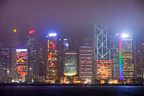Office blocks lit up at night with Hong Kong, China. February 2010.