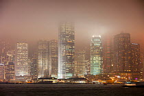 Office blocks lit up at night with Hong Kong, China. February 2010.