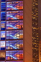 Office blocks lit up at night in Hong Kong, China. February 2010.