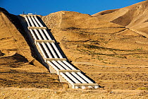 Pumping station sending water uphill over the mountains on the California aquaduct that brings water from snowmelt in the Sierra Nevada mountains to farmland in the Central Valley, California, USA, Se...