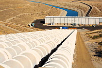 Pumping station sending water uphill over the mountains on the California aquaduct. This brings water from snowmelt in the Sierra Nevada mountains to farmland in the Central Valley. California, USA, S...