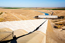 Pumping station sending water uphill over the mountains on the California aqueduct. This brings water from snowmelt in the Sierra Nevada mountains to farmland in the Central Valley. California, USA, S...