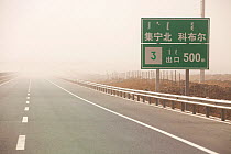 Dust storm sweeping across highway in Inner Mongolia during severe drought, China, March 2009.