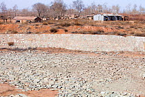 Village water storage reservoir which has completely dried up during drought. Shanxi province, China. March 2009.