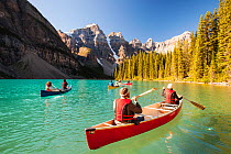 People in canoes on Moraine Lake in the Canadian Rockies, Banff National Park, Canadian Rockies, Alberta, August 2012.