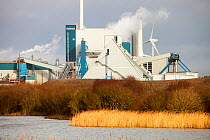 The new biofuel power plant at the Iggesund paper board manufacturer in Workington, Cumbria, UK with wind turbines behind. When commissioned the power station will fuel the plant as well as feeding po...