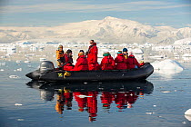 Members of an expedition cruise to Antarctica in a Zodiac in Fournier Bay, Gerlache Strait, Antarctic Peninsula.