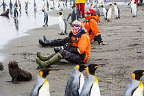 King penguins (Aptenodytes patagonicus), with passengers from an expedition cruise. Salisbury Plain, South Georgia Islands.