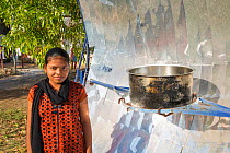 Woman with solar cooker, Muni Seva Ashram in Goraj, near Vadodara, India. December 2013.