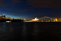 Sydney harbour at night witht the Sydney Opera House and Sydney Harbour Bridge, Australia.