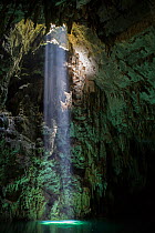 Light shining into Abismo Anhumas or Anhumas Abyss. This is a 80 metre deep lake, at the bottom of a 72 metre deep cave. Bonito area, Serra da Bodoquena (Bodoquena Mountain Range), Mato Grosso do Sul...