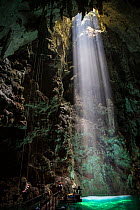 Light shining into Abismo Anhumas or Anhumas Abyss. This is a 80 metre deep lake, at the bottom of a 72 metre deep cave. Bonito area, Serra da Bodoquena (Bodoquena Mountain Range), Mato Grosso do Sul...